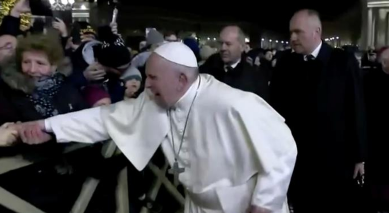 Pope Francis pulls away from the woman. Pope Francis