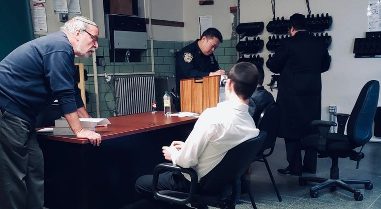 Hikind with the teens as they reported the incident. Dov Hikind