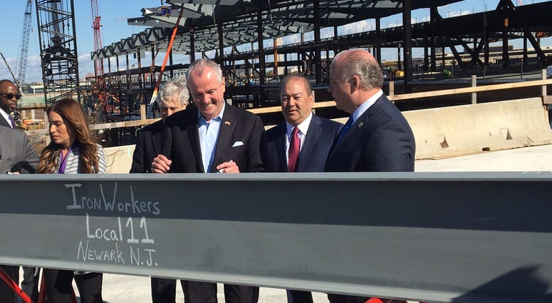 Steelworkers raised the final steel beam for the exterior of the new Terminal 1 on Wednesday, Oct. 23, 2019, with New Jersey Gov. Phil Murphy. Gov. Murphy Newark Airport