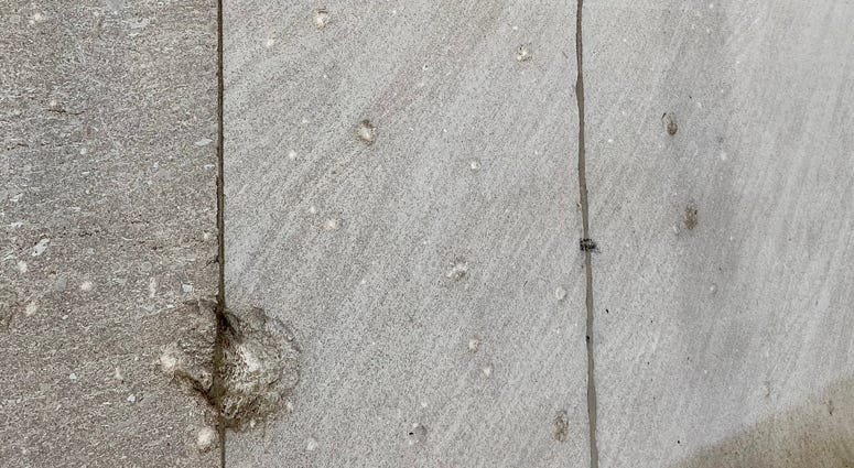 Damage is still seen on 23 Wall Street, 100 years after a bombing. Wall Street bombing markings