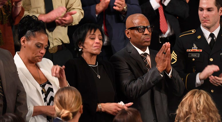 Guests of President Donald Trump, Elizabeth Alvarado, Evelyn Rodriguez, and Freddy Cuevas stand as they are acknowledged by President Trump during the State of the Union address. Evelyn Rodriguez