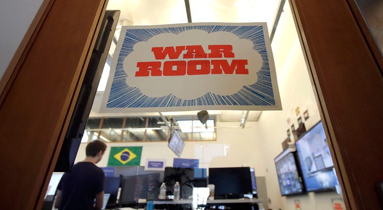 A man works at his desk in the war room, where Facebook monitors election related content on the platform, in Menlo Park, Calif., Wednesday, Oct. 17, 2018. Facebook War Room