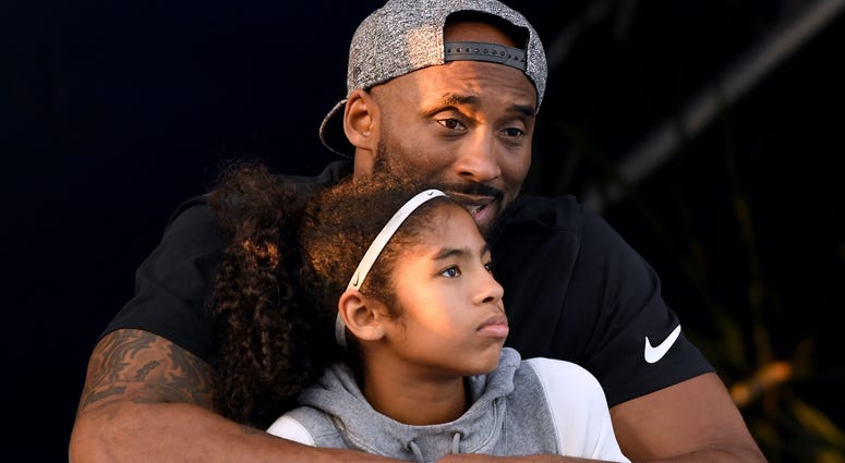 Kobe Bryant and daughter Gianna Bryant watch during day 2 of the Phillips 66 National Swimming Championships. Kobe Bryant Gianna