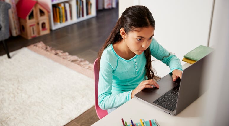 Child working on computer Child working on computer