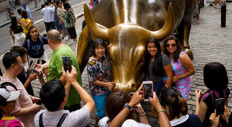 Tourists with Charging Bull Statue Tourists with Charging Bull Statue