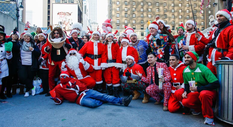 People pose as they take part during the annual New York SantaCon on December 8, 2018 in New York City. SantaCon is in it's 20th year in New York City. SantaCon 2018