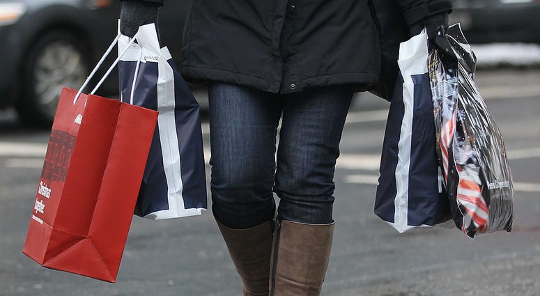 A woman carries shopping bags two days before Christmas on December 22, 2010 in Berlin, Germany. Christmas Shopping - Returns