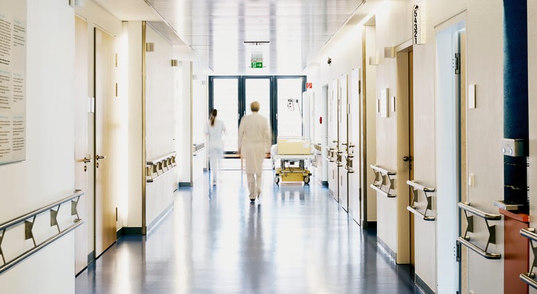 A blurred image of a hospital corridor. Hospital Corridor