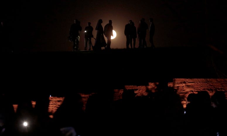 The moon rises over the Columbine Memorial during a candle light vigil on April 19, 2019 in Littleton, Colorado. Columbine anniversary