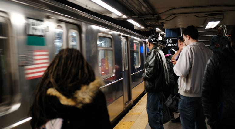 People wait for a subway in Manhattan on April 22, 2019 in New York City. subway in Manhattan