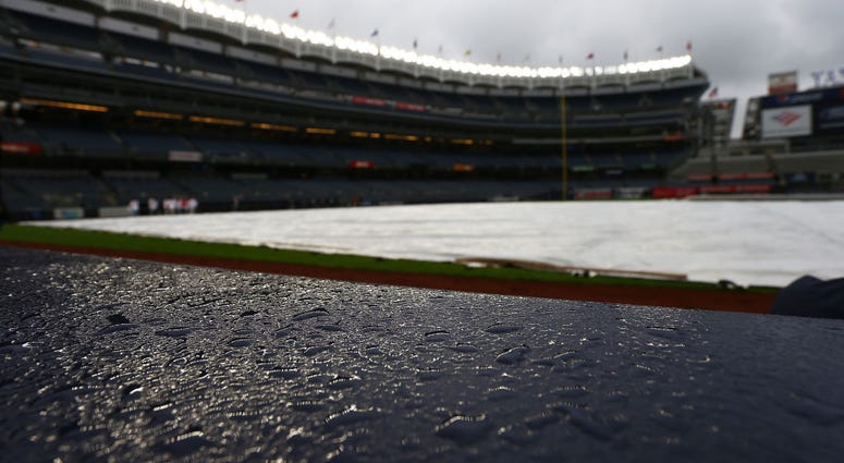The tarp is seen on the field prior to the game between the Baltimore Orioles and the New York Yankees at Yankee Stadium on May 14, 2019 Yankee Stadium Tarp