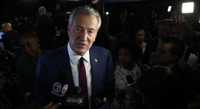 New York City Mayor Bill De Blasio speaks to the media in the spin room following the first night of the Democratic presidential debate on June 26, 2019 in Miami, Florida. Mayor de Blasio