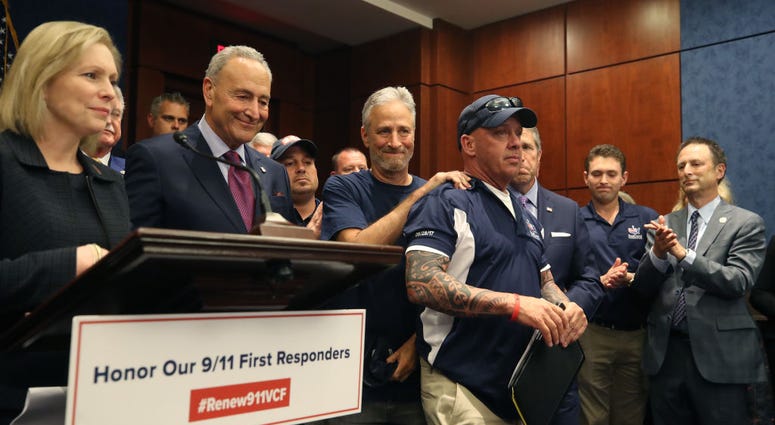 Jon Stewart (2R) hugs 911 first resonder and FealGood Foundation co-founder John Feal (R) after the U.S. Senate voted to renew permanent authorization of September 11th Victim Compensation Fund, on Capitol Hill July 23, 2019 in Washington, DC. Senate - 9/11 VCF Vote