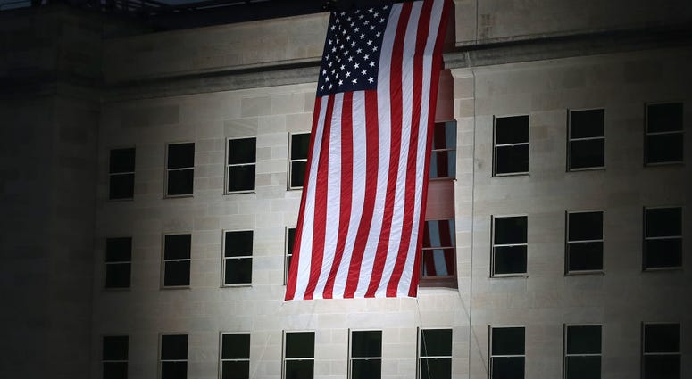 An American flag is unfurled on the side of the Pentagon to commemorate the anniversary of the 9/11 terror attacks September 11, 2019 in Arlington, Virginia. 9/11 Pentagon