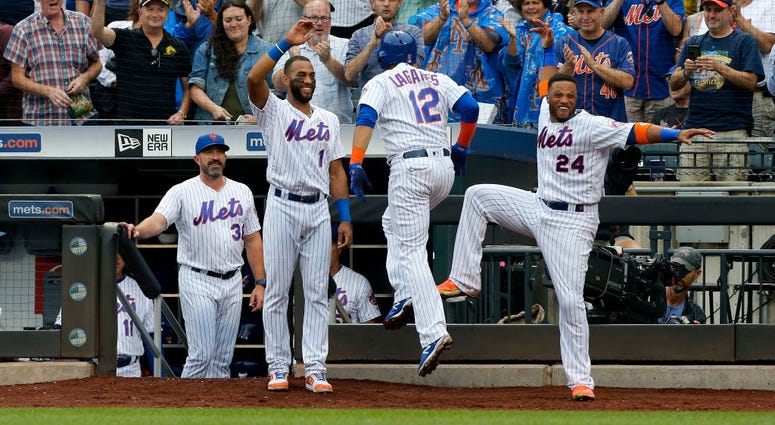 Juan Lagares #12 of the New York Mets celebrates his third inning grand slam home run against the Arizona Diamondbacks with teammates Amed Rosario #1 and Robinson Cano #24 and manager Mickey Callaway #36 at Citi Field on September 12, 2019 in New York Cit Mets Sweep