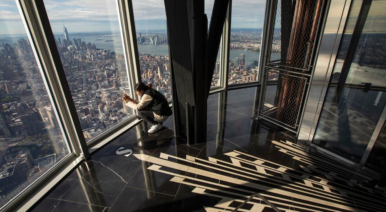 A woman takes in views of Manhattan from the newly renovated 102nd-floor observatory of the Empire State Building on October 10, 2019. Empire State Building Observatory