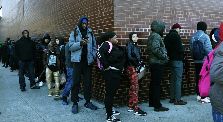 People wait in line for a job fair at a United Parcel Service (UPS) facility on November 01, 2019 in New York City. Unemployment line