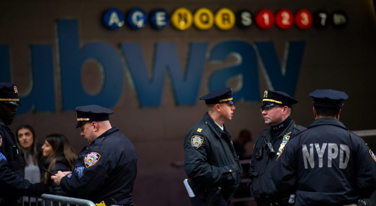 NYPD officers patrol the subway station as people arrive to celebrate New Years Eve in Times Square on December 31, 2019 in New York City. NYPD subway