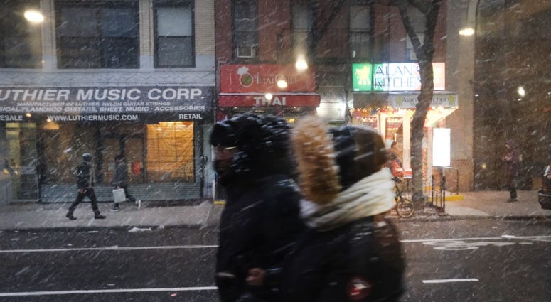 People walk through a snow squall in midtown Manhattan on December 18, 2019 in New York City. Wintery Weather New York City (Snow/Rain)