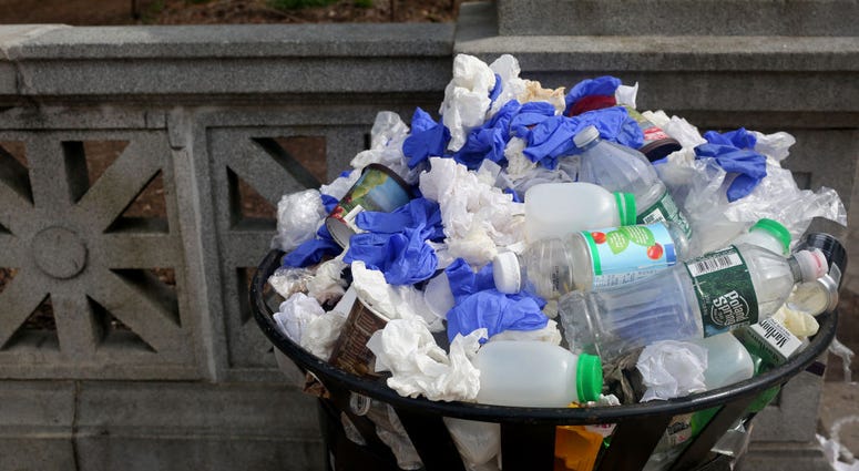 A garbage can overflows with gloves near Prospect Park Market during nice weekend weather as social distancing guidelines remain in place to limit the spread of coronavirus on May 2, 2020 in New York City. New York City trash can
