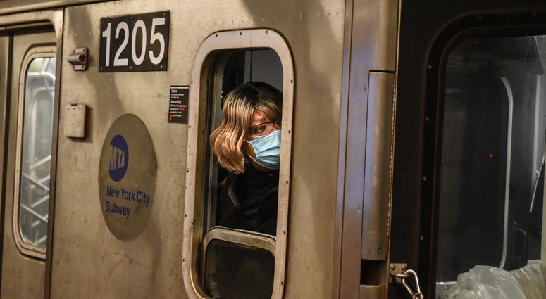 A train conductor wears a protective mask while riding on a subway through the Fulton St. station on May 6, 2020 in Manhattan in New York City. Coronavirus NYC