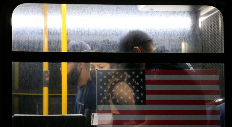 Activists are detained by the New York Police Department (NYPD) on an MTA bus as a rally is held in response to the police killing George Floyd in front of Barclays Center on May 29, 2020 in Brooklyn Protester on bus