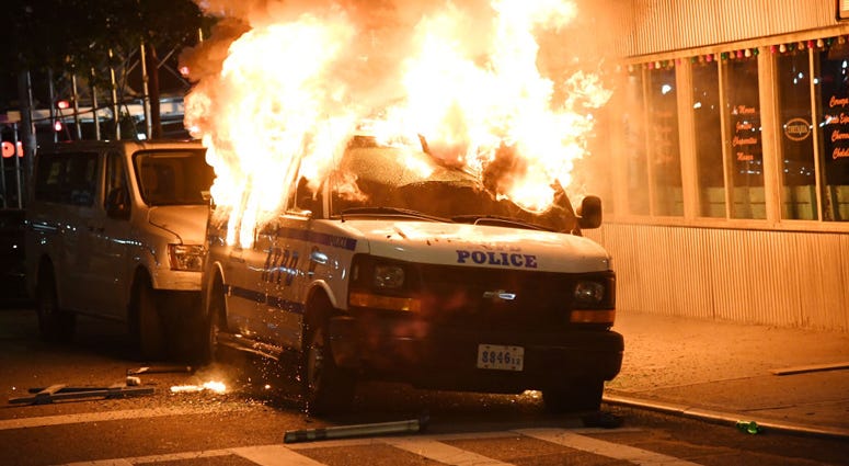 FDNY Firefighters work to put out fires on NYPD vehicles caused by protesters near Union Square who are protesting the recent killing of George Floyd on May 30, 2020 in New York City. New York City George Floyd Protest