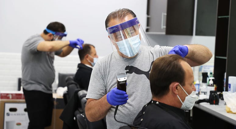 Yury Badalbayev cuts the hair of Paul Hayden at Barber Crew by Yury on June 10, 2020 in Bellmore, New York. Long Island barber shop