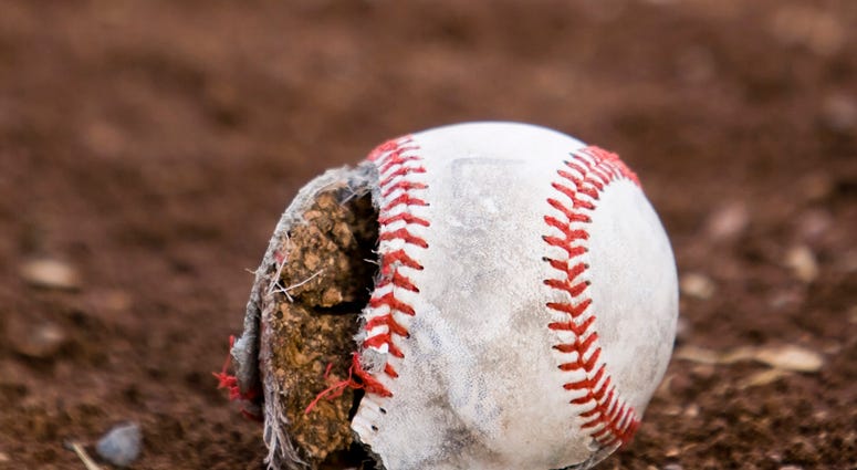 Worn out baseball laying in dirt Old Baseball Field