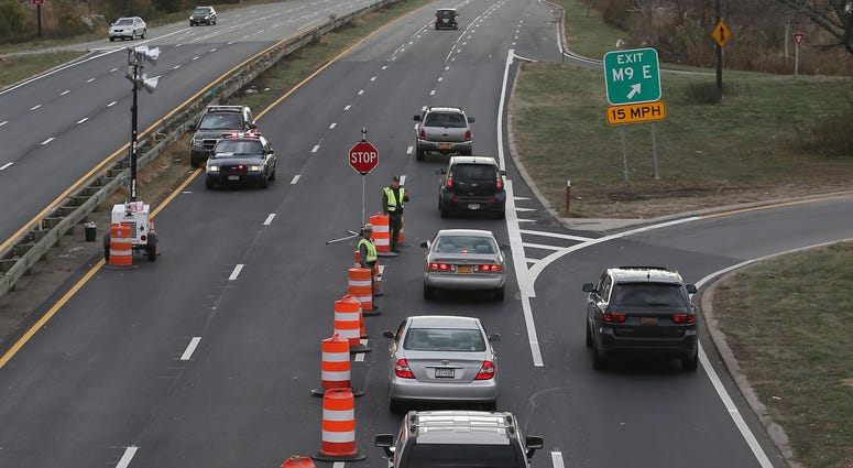 In the aftermath of Superstorm Sandy, New York State Police restrict traffic on Meadowbrook Parkway to residents of Long Beach and adjoining areas on November 2, 2012 in Freeport, New York. Meadowbrook Parkway