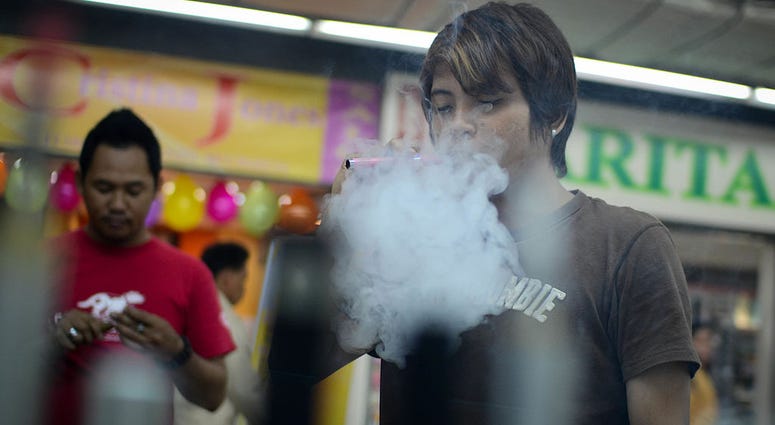 Consumers smoke electronic cigarettes at a mall on June 30, 2013 in Manila, Philippines. Vaping