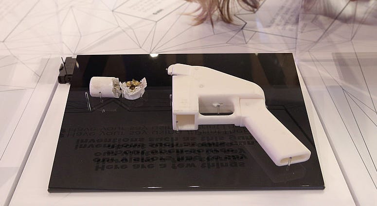 A woman admires a 3D printed handgun which was created and fired by Finnish journalist Ville Vaarne and which is displayed in the exhibition '3D: printing the future' in the Science Museum on October 8, 2013 in London, England. Ghost Gun