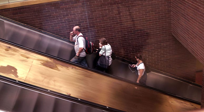 People ride an escalator at the Port Authority Bus Terminal on August 21, 2014 in New York City. Port Authority Escalator