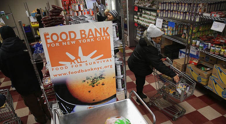 arlem residents choose free groceries at the Food Bank For New York City on December 11, 2013 in New York City. Food Bank
