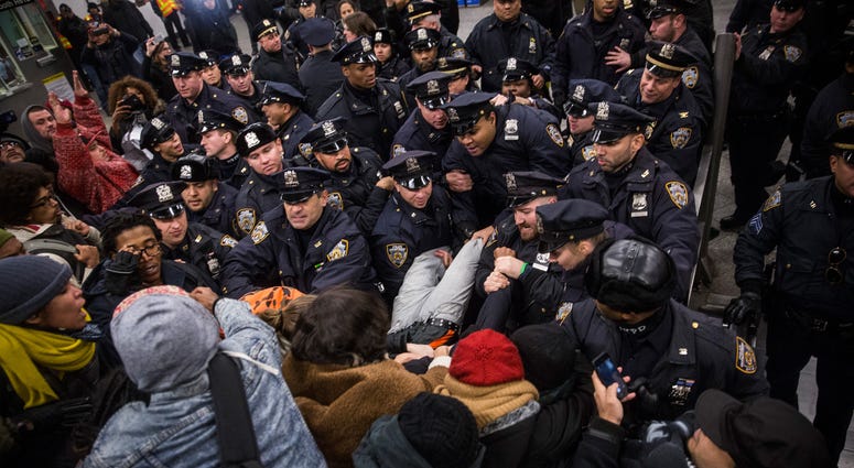 Police clash with demonstraters protesting the Staten Island, New York grand jury's decision not to indict a police officer involved in the chokehold death of Eric Garner in July inside the Barclays Center subway station. Subway protest NYPD