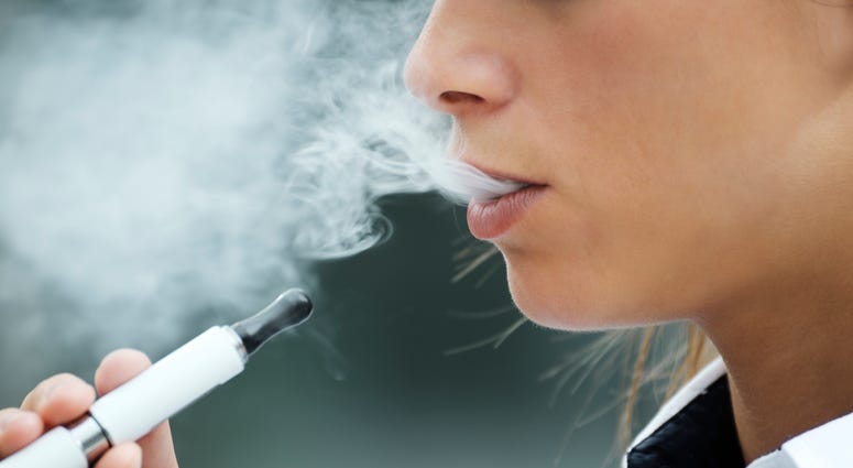 Close up of a woman smoking an e-cigarette Vaping