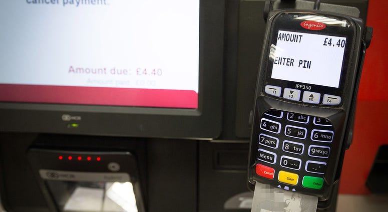 In this photo illustration a debit card is seen in a chip and pin machine on May 21, 2015 in Bristol, England. Cashless Store