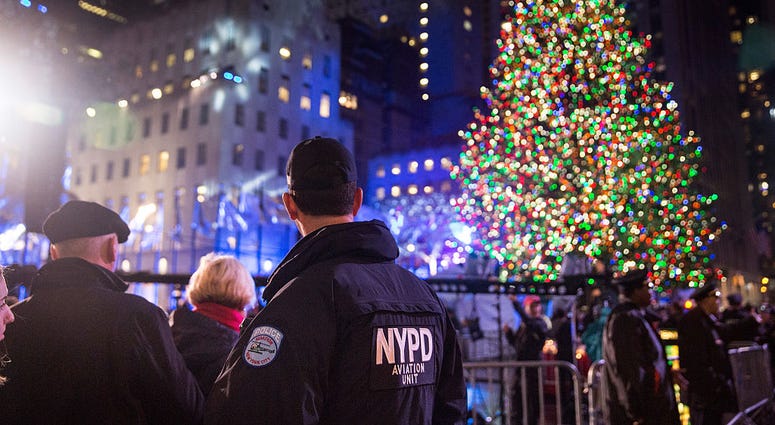 Police officers stand guard at the Rockefeller Center complex during the annual lighting of the Rockefeller Center Tree on December 2, 2015 in New York City. Rockefeller Tree Security