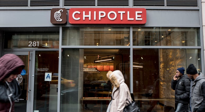 People walk past a Chipotle restaurant on Broadway in Lower Manhattan on February 8, 2016 in New York City. Chipotle
