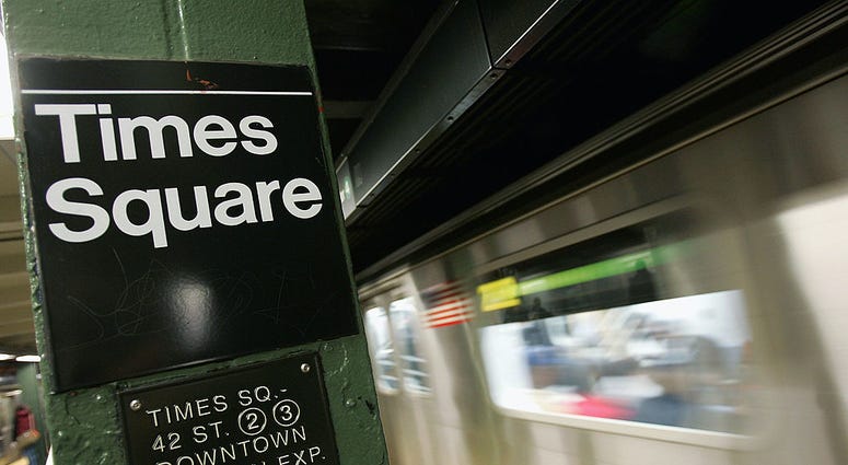A subway trains enters Times Square October 26, 2004 in New York City. Times Square