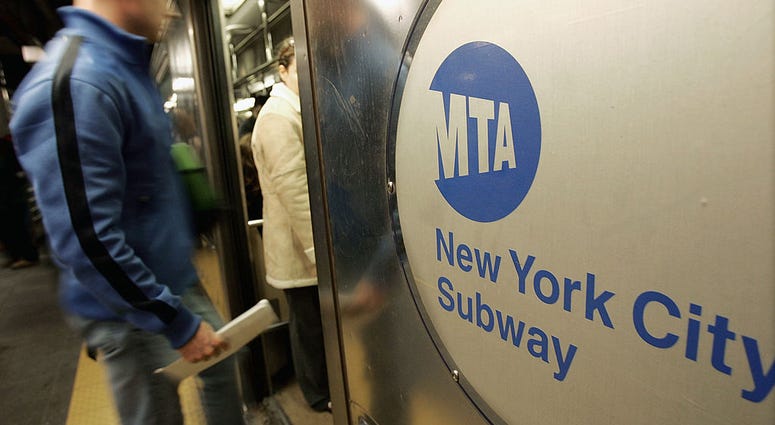 People enter a subway car at Times Square October 26, 2004 in New York City. New York City Subway