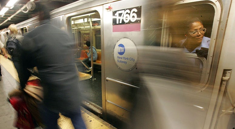 A subway conductor looks out onto the platform at the Times Square subway station October 9, 2005 in New York City. Blurred Subway Train