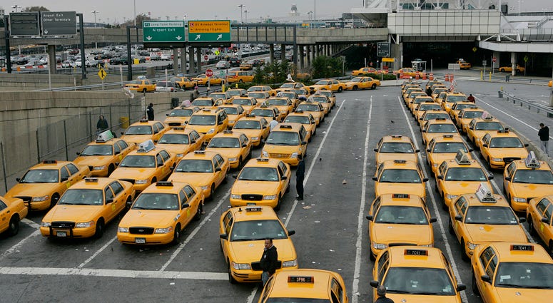 Taxis wait in line for returning holiday travelers November 27, 2005 at LaGuardia Airport. Taxis at LaGuardia Airport