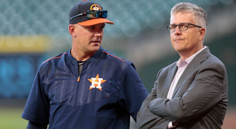 Manager AJ Hinch of the Houston Astros and general manager Jeff Luhnow talk during batting practice at Minute Maid Park on April 4, 2017 in Houston, Texas. AJ Hinch and Jeff Luhnow