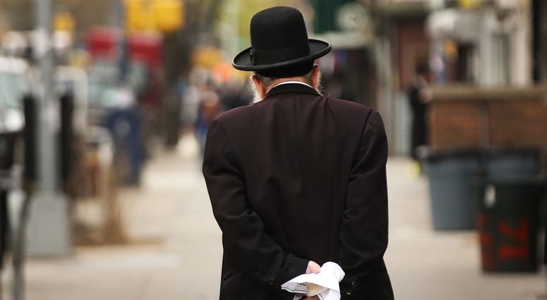 A Hasidic man walks through a Jewish Orthodox neighborhood in Brooklyn. Hasidic man