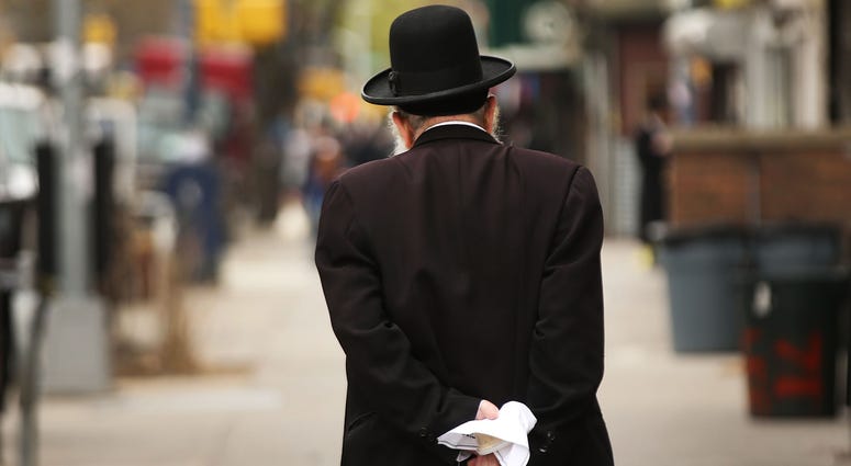 A Hasidic man walks through a Jewish Orthodox neighborhood in Brooklyn on April 24, 2017 in New York City. Hasidic Brooklyn