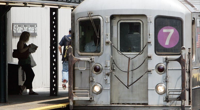 A commuter waits to ride the 7 subway train June 19, 2006 in New York City. 7 train subway