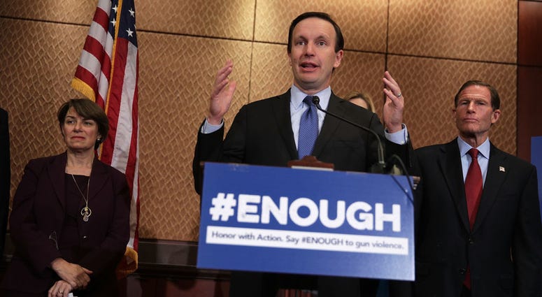 Sen. Chris Murphy (D-CT) (2nd L) speaks as Sen. Richard Blumenthal (D-CT) (R) and Sen. Amy Klobuchar (D-MN) (L) listen during a news conference October 3, 2017 on Capitol Hill in Washington, DC. Sen. Chris Murphy
