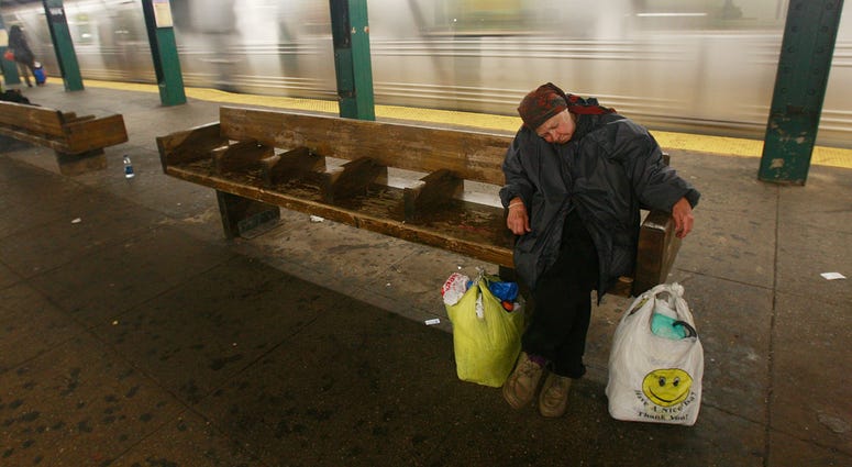 A woman sleeps on a subway platform April 3, 2009 in New York City. Homeless in subway