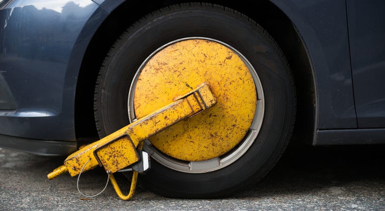 A boot on a car tire. Tire boot